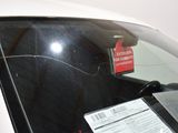 a sticker on the windshield of a car that has a price tag attached to it