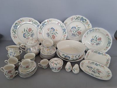many different types of dishes and cups on the table
