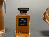 a bottle of eau arrege next to a bottle of perfume