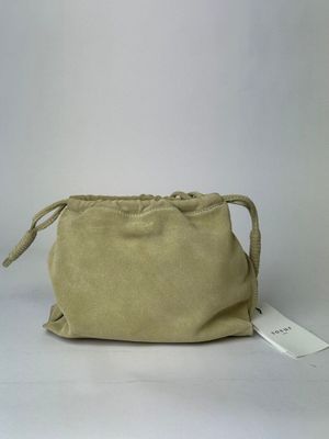 beige sued pouch with a tag on it sitting on a white surface