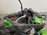 a close up of a green motorcycle parked in a garage