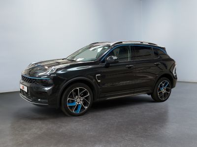the black suv is parked in a room with a white wall