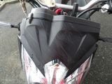 a close up of a motorcycle with a black umbrella on the handlebars