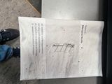 a person holding a piece of paper with a drawing on it