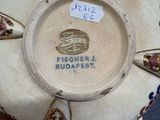 someone is holding a plate with a picture of a crown on it
