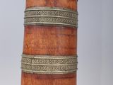 a wooden and metal container on a stand on a white surface