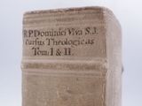 an old book sitting on top of a wooden table on top of a table