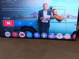 a flat screen tv with a picture of a man and a woman on it