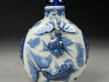 a blue and white vase with a fish design on it