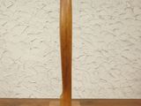 a wooden sculpture of a surfboard on a table