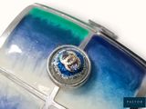 a picture of a blue and green glass case with a diamond in it