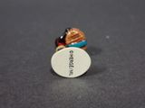 a small miniature figurine of a person with a hat on it