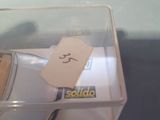 a small toy car in a box with a price tag on it