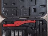 a black case with a red handle and a wrenet in it
