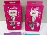 two boxes of venus razors on a white table