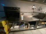 a kitchen with stainless steel counter tops and a microwave