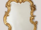 an image of a gold mirror with a decorative frame
