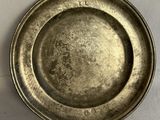 a silver plate that is on a white table