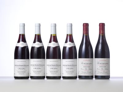 six bottles of wine are lined up on a table