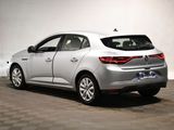 the rear end of a silver car in a white room