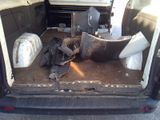 the back of a van with a bunch of items in the trunk