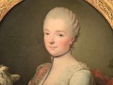 portrait of a lady with a dog and a bird in a gold frame