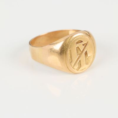 an image of a gold signet ring with the letter k on it
