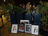 a table with a bunch of pictures and plants on it