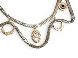 a silver necklace with gold and blue stones on it