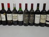 several bottles of wine are lined up in a row on a table