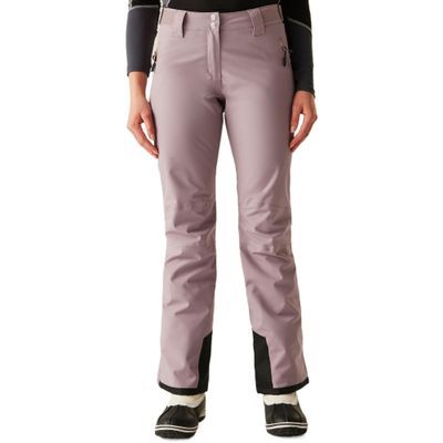 a woman in a black top and purple pants standing on a white background