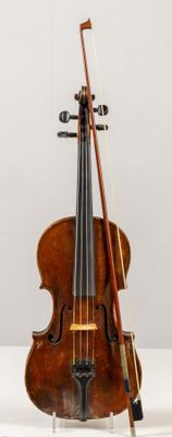 a violin and a bow on display on a table
