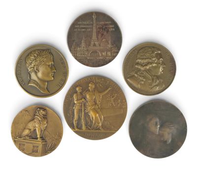 four different types of bronze medals on a white surface