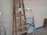 a ladder leaning against a wall with a sign on it