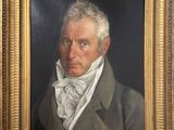 painting of a man in a suit with a bow tie in a gold frame