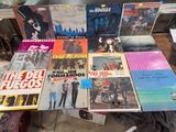 a lot of vinyl records on a table in a room