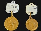 two gold medals with the image of jesus and a woman on them