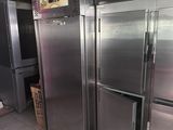 several stainless steel refrigerators are lined up in a kitchen