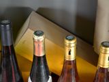several bottles of wine are lined up in a row on a table