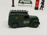a green toy truck with a fireman on top of it