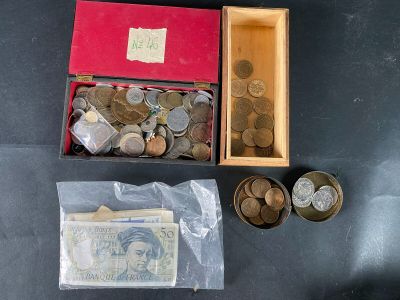 a box of coins and a box of money on a table