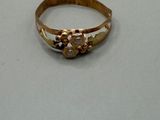 an image of a gold ring on a white surface
