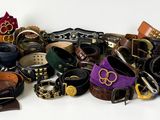 a lot of different types of belts on a white surface