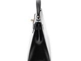 black and white handbag on a white background with a gold handle