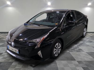a picture of a black toyota prius parked on a checkered floor