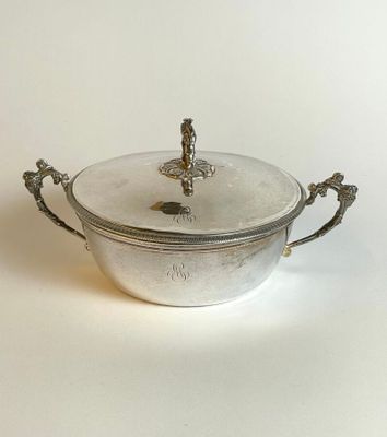 a silver pot with a lid on a white surface