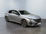 a silver car is parked in a room with a white wall