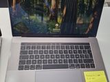 a laptop computer sitting on a desk with a note on it