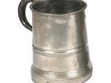 a small silver cup with a handle on a white background