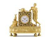 une horloge en or sur laquelle figurent un homme et un chien
